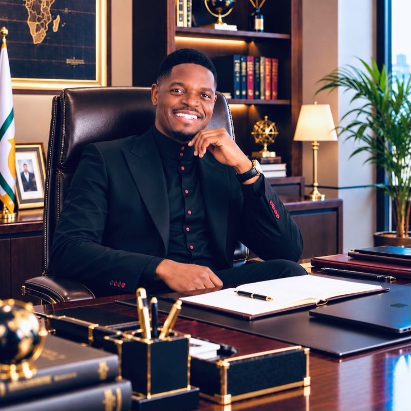 Shacky Timburwa at his desk with an open notebook